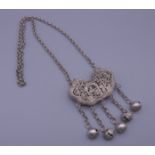 A Chinese silver pendant on chain. Pendant 6.