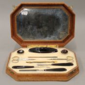 A leather jewellery box and a manicure set. The former 18 cm wide.