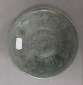 A small celadon dish decorated with calligraphy. 15.75 cm diameter.