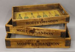 A set of three wooden trays