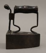 A 19th century iron with turned wooden handle. 10 cm high.