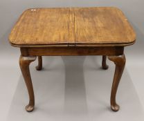 An early 20th century mahogany dining table with unusual extending action, by Waring & Gillows.