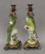 A pair of porcelain parrot form candlesticks. 35 cm high.