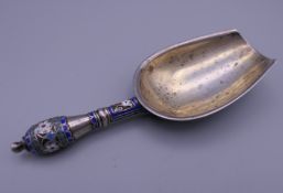 A Russian silver sugar spoon, stamped 'Made for Tiffany & Co'. 10.75 cm long.