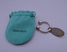 A Tiffany silver key ring in a Tiffany pouch. 6 cm long.