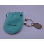 A Tiffany silver key ring in a Tiffany pouch. 6 cm long.