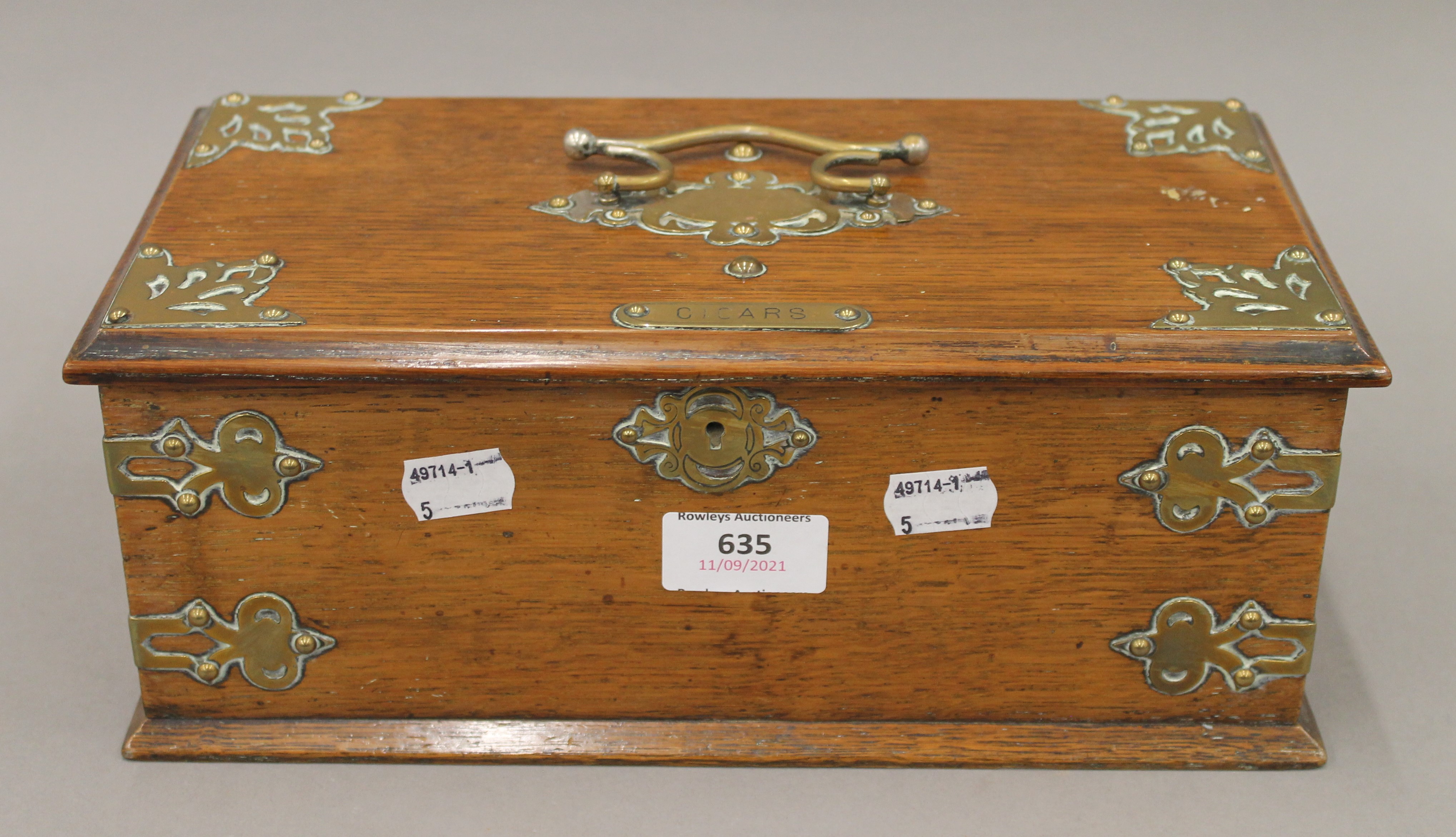 A Victorian brass mounted oak cigar box. 29 cm wide.
