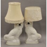 Two 19th century Staffordshire pottery dogs mounted as table lamps.