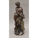 A 19th century terracotta semi-naked figure of a Nubian slave girl in handcuffs, signed J Jacques.