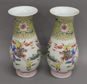 A pair of Chinese porcelain vases decorated with warriors. 43 cm high.