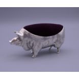 A pin cushion formed as a pig. 10.5 cm long, 5.25 cm high.