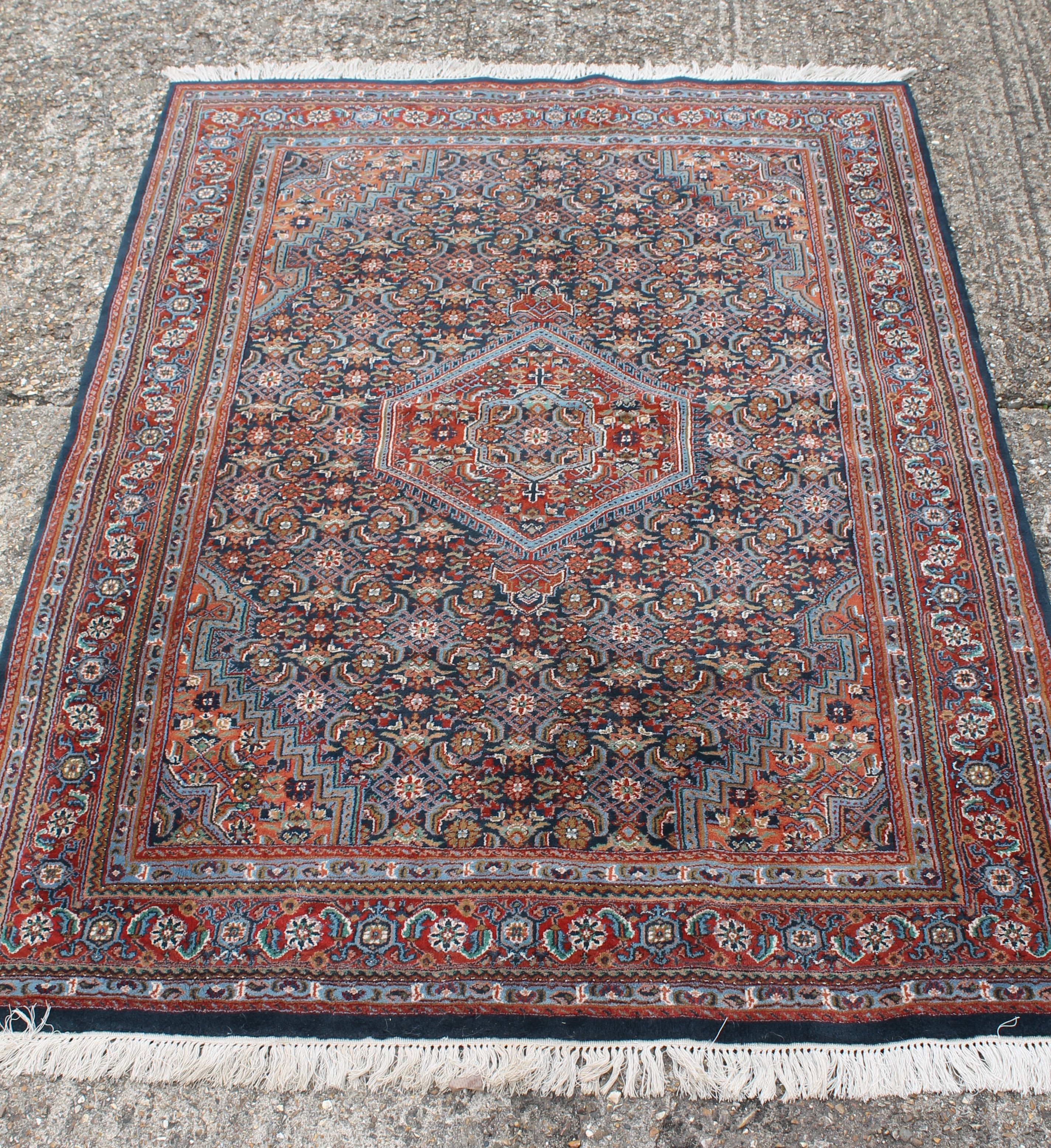 An Indian hand knotted wool rug. 233 x 169 cm.