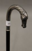 A walking stick with horse head handle in silver, crown and moon mark, and 925 stamp. 92 cm long.