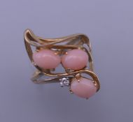 A 14 K gold, coral and diamond ring. 4.4 grammes total weight.