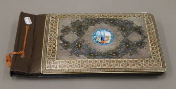 A Kashmiri photograph album with unmarked silver mounts. 36.5 cm wide.