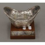 A silver clad Hong Kong Jockey Club trophy mounted on a wooden presentation plinth.