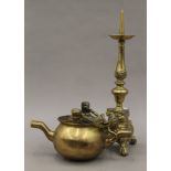 An antique double spouted brass cooking pot with swing handles for suspension and a pricket