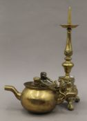 An antique double spouted brass cooking pot with swing handles for suspension and a pricket