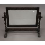 An early 20th century carved oak framed dressing table mirror. 68 cm wide.