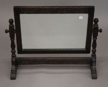 An early 20th century carved oak framed dressing table mirror. 68 cm wide.