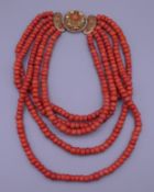 A coral five strand necklace with an 18 ct gold clasp. 40 cm long. 307.4 grammes total weight.