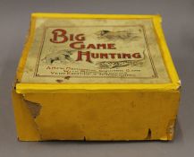 A vintage boxed Big Game Hunting mechanical toy. The box 20 cm wide.