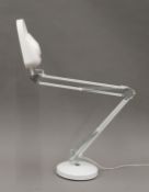 An angle poise magnifying lamp.