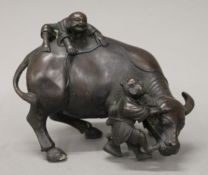 A bronze model of boys and a bull. 17 cm long.