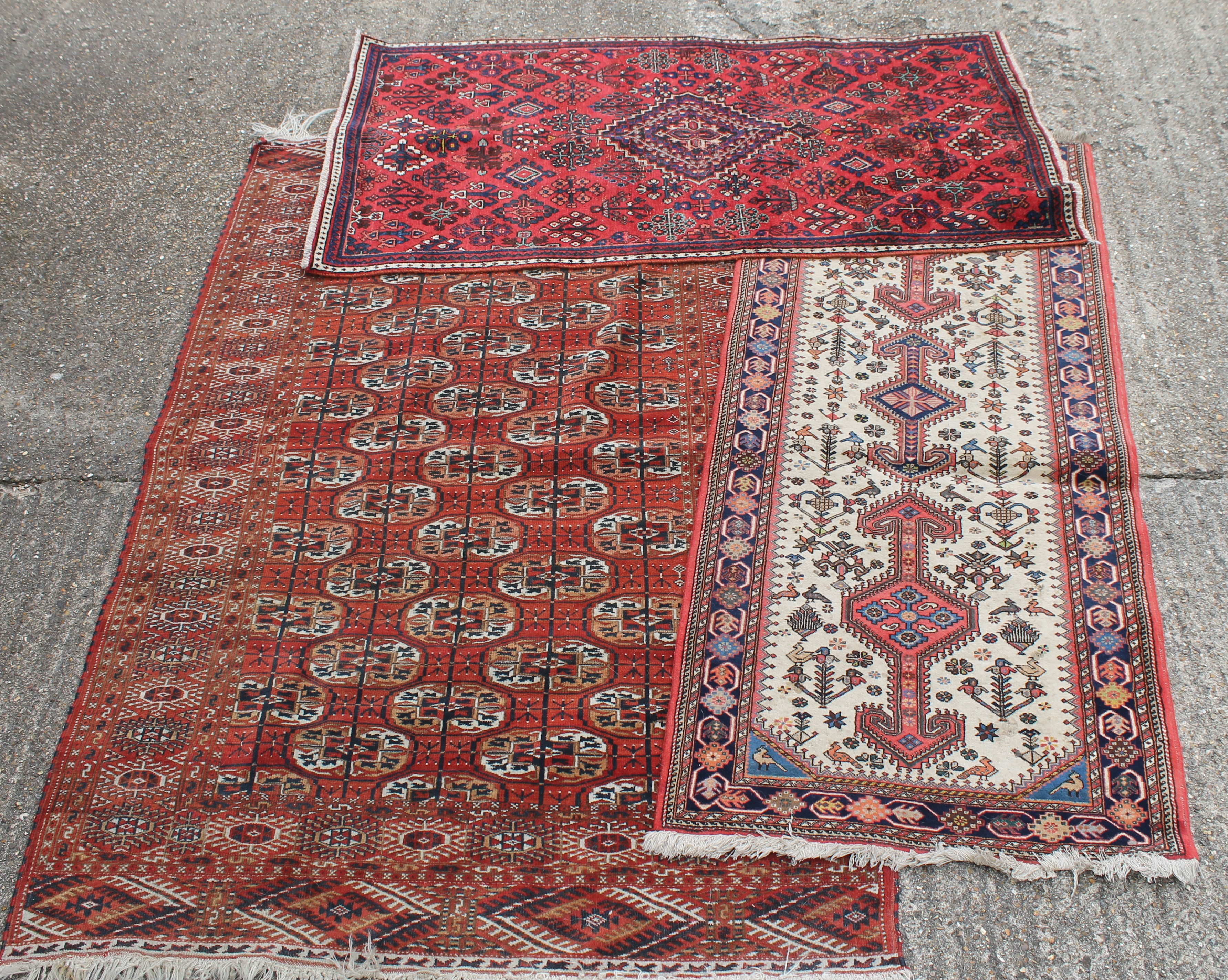 Three Persian wool rugs. The largest 131 x 205 cm.
