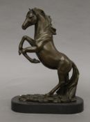 A bronze model of a rearing horse on a plinth base. 33 cm high.
