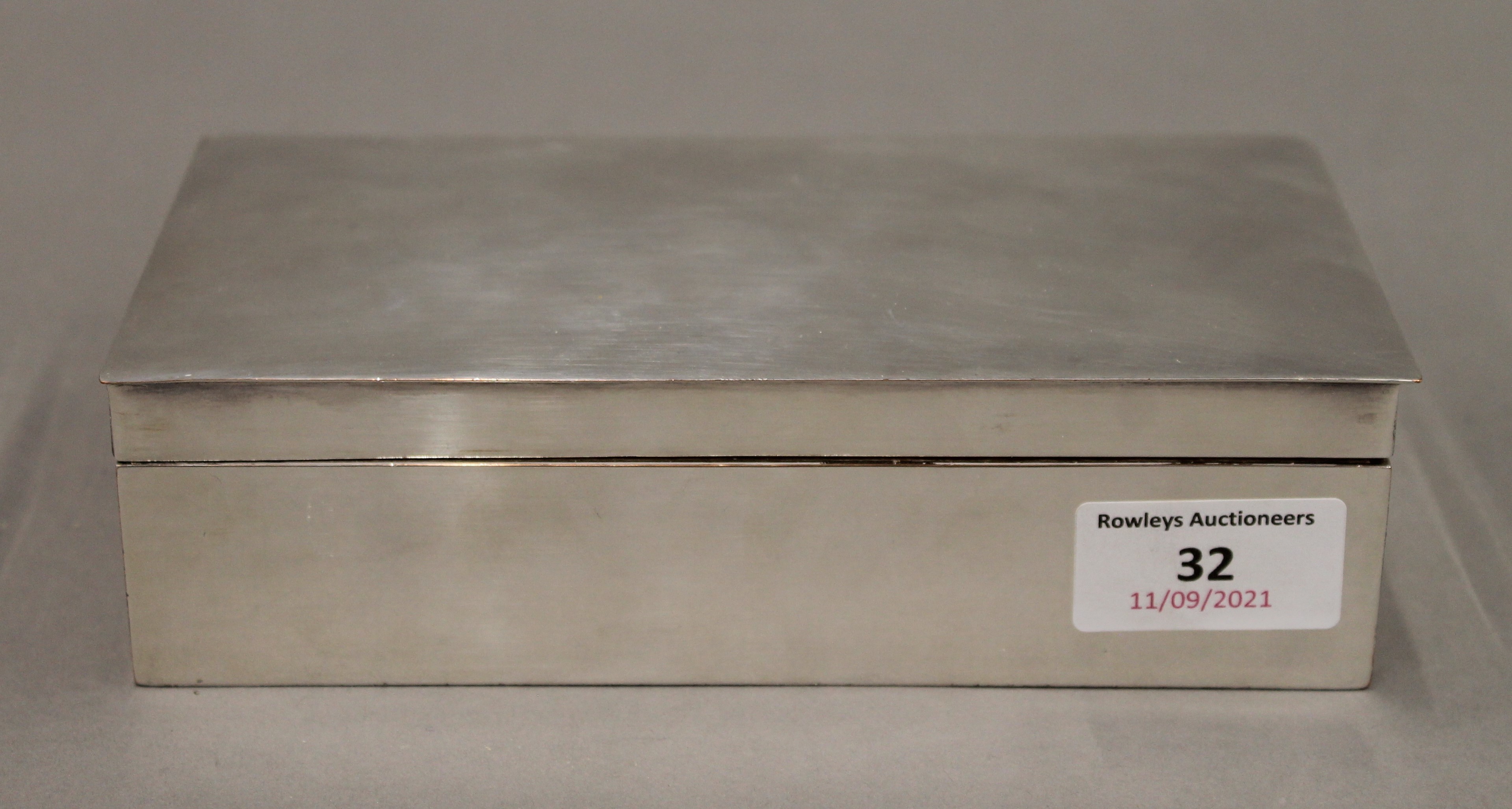 A silver plated cigarette box. 18 cm wide.