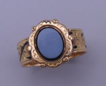 An 18 ct gold mourning ring. Ring size T/U. 7.2 grammes total weight.