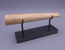 A late 19th century oversized cigar holder carved in ivory with stand. Cigar holder 18.5 cm long.