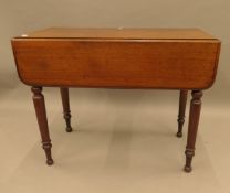 A Victorian mahogany Pembroke table. 87 cm long.