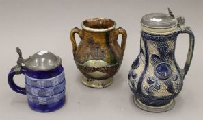 Two 19th century German steins and a jug. The largest 24 cm high.