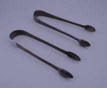 Two pairs of silver tongs. 14.25 cm long. 65.6 grammes.