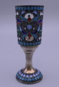 A Russian silver and enamel vodka tot. 8 cm high. 44.4 grammes total weight.