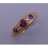 An 18 ct gold ruby and diamond ring. Ring size R/S. 3.9 grammes total weight.