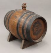 An oak spirit barrel on stand. 27.5 cm long.