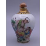 A snuff bottle decorated with an erotic scene. 8.5 cm high.