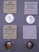 Four silver proof cased coins, with certificates.
