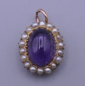 A gold, amethyst and pearl pendant. 2 cm x 1.5 cm.