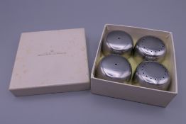 A Georg Jensen silver condiment set, in original box. Each 2.5 cm high.