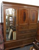 An Edwardian inlaid mahogany compactum wardrobe. 182 cm wide.