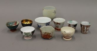 Ten various porcelain sake cups.