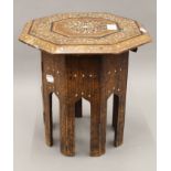 An Indian inlaid folding table. 30 cm diameter.