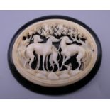 A fine Victorian Whitby jet brooch carved with greyhounds in ivory. 6.5 cm wide.