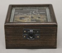 A square sundial compass in box. The box 9.5 cm wide.