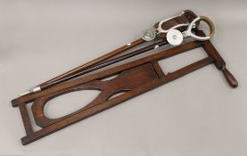 A Victorian boot jack and two shooting sticks. The former 86.5 cm high.