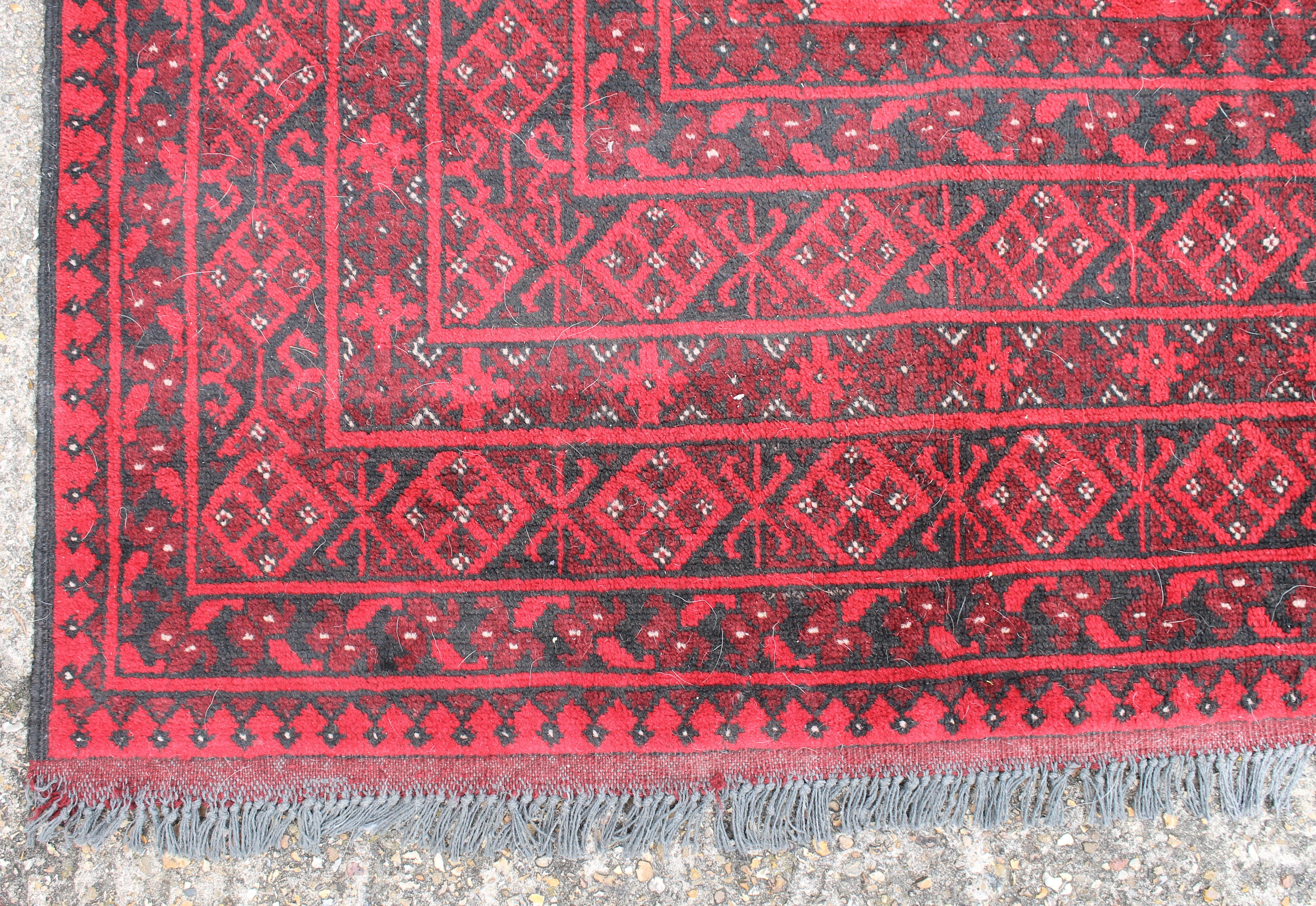 A red ground Balouch rug. 288 x 195 cm. - Image 2 of 3